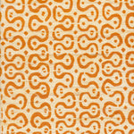 Detail of fabric in a curvilinear stripe pattern in orange on a cream field.