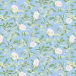 Detail of wallpaper in a floral print in shades of white and green on a light blue field.