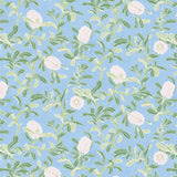 Detail of wallpaper in a floral print in shades of white and green on a light blue field.