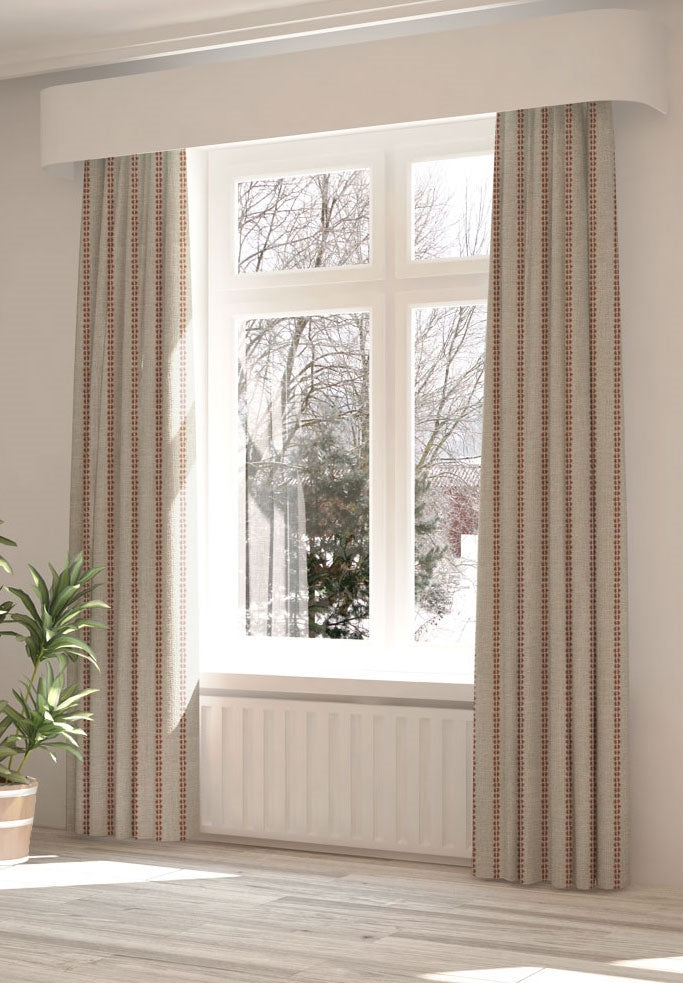 A large, sunny window with long curtains in a playful dot print on a cream field.