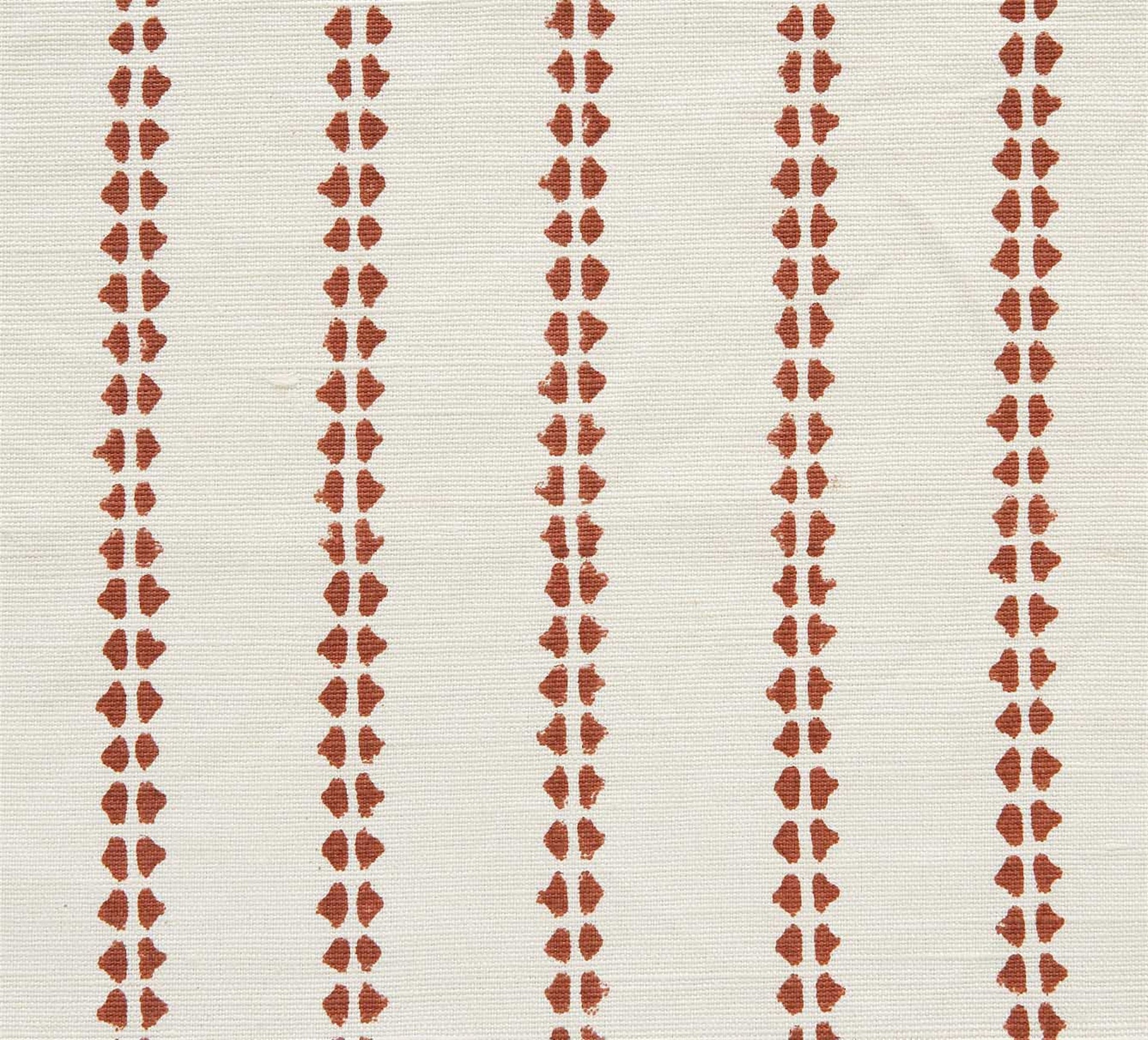 Detail of fabric in a playful ticking stripe print in rust on a white field.