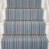 Striped flatweave runner in blue  and red on white staircase