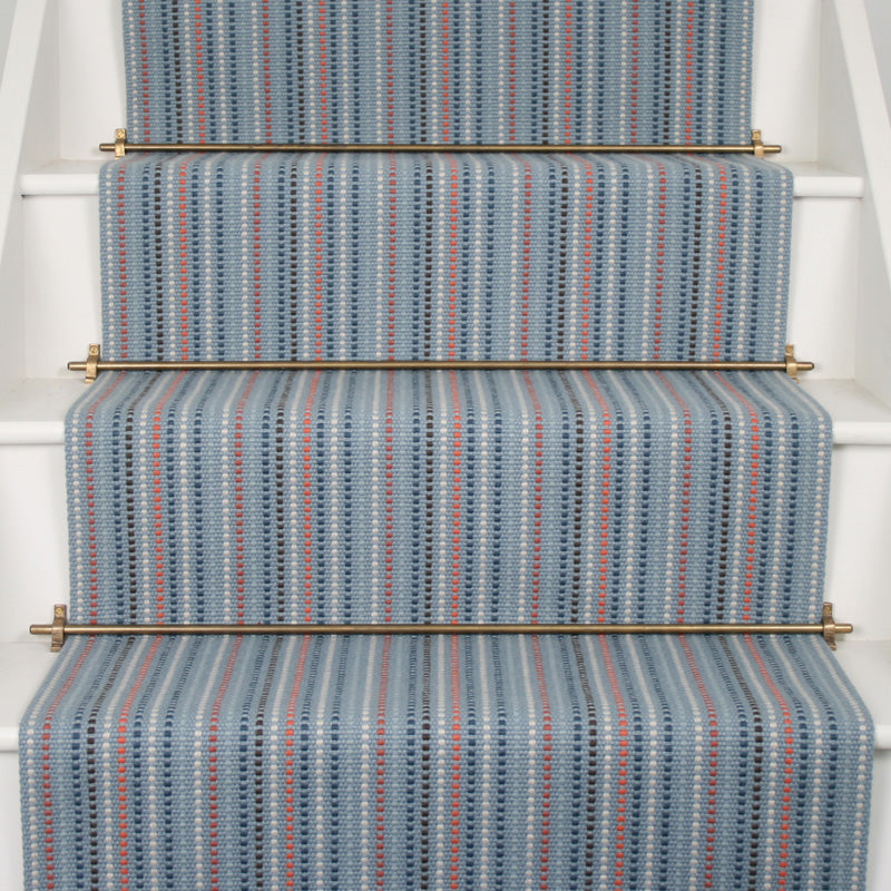 Striped flatweave runner in blue  and red on white staircase