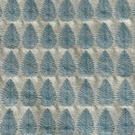 Detail of fabric woven in a repeating leaf print in shades of blue and gold.