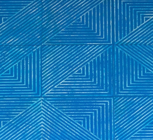 Detail of a leather wall tile in an angular geometric pattern in blue and white.