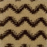 Close-up of a patterned carpet with black and beige zig zag design