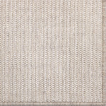 Close-up of a textured beige rug with a subtle pattern