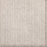 Close-up of a textured beige rug with a subtle pattern