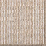 Close-up of a textured beige carpet with a subtle pattern