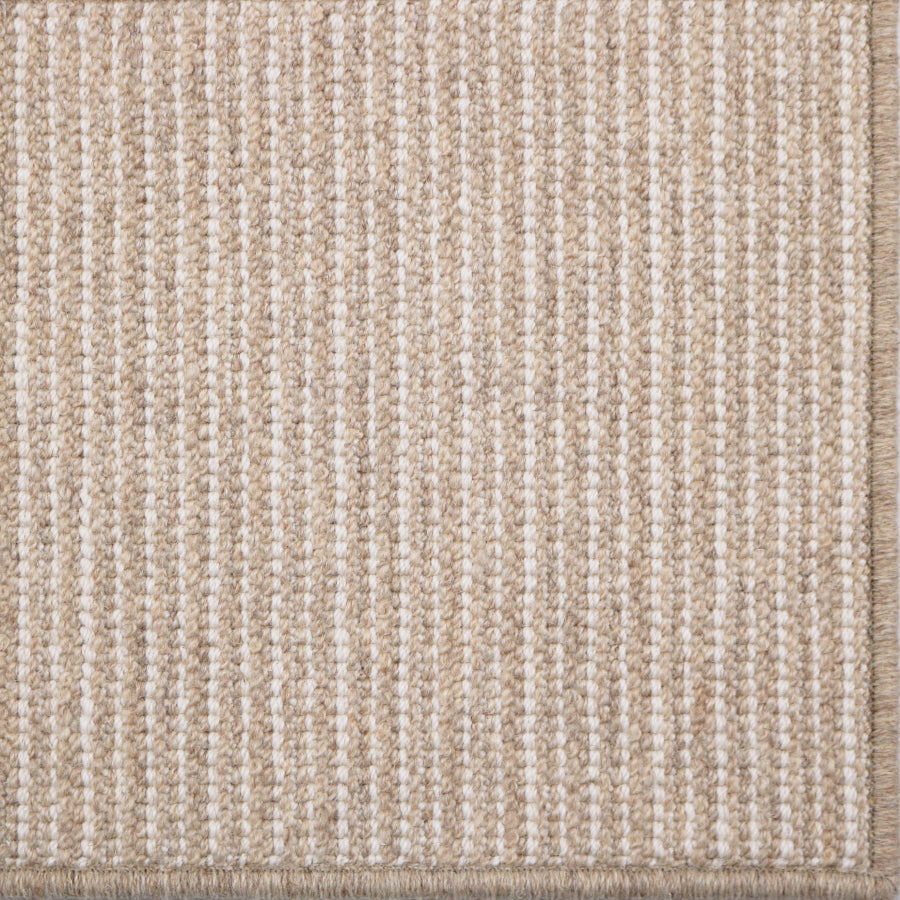 Close-up of a textured beige carpet with a subtle pattern