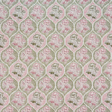 Detail of fabric in a floral damask print in shades of pink and green on a cream field.