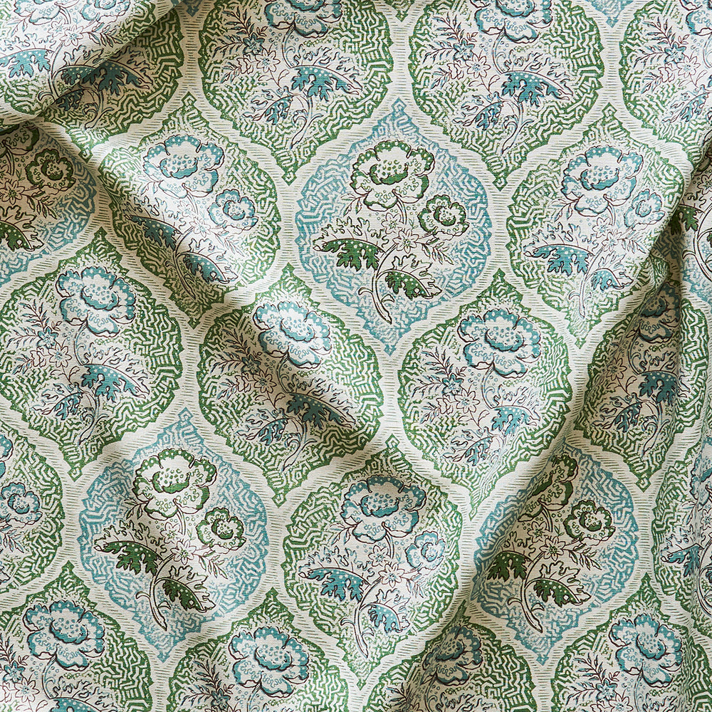 Draped fabric yardage in a floral damask print in shades of gray, blue and green on a cream field.