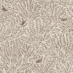 Detail of fabric in a playful bird and leaf print in brown on a cream field.