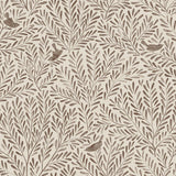 Detail of fabric in a playful bird and leaf print in brown on a cream field.