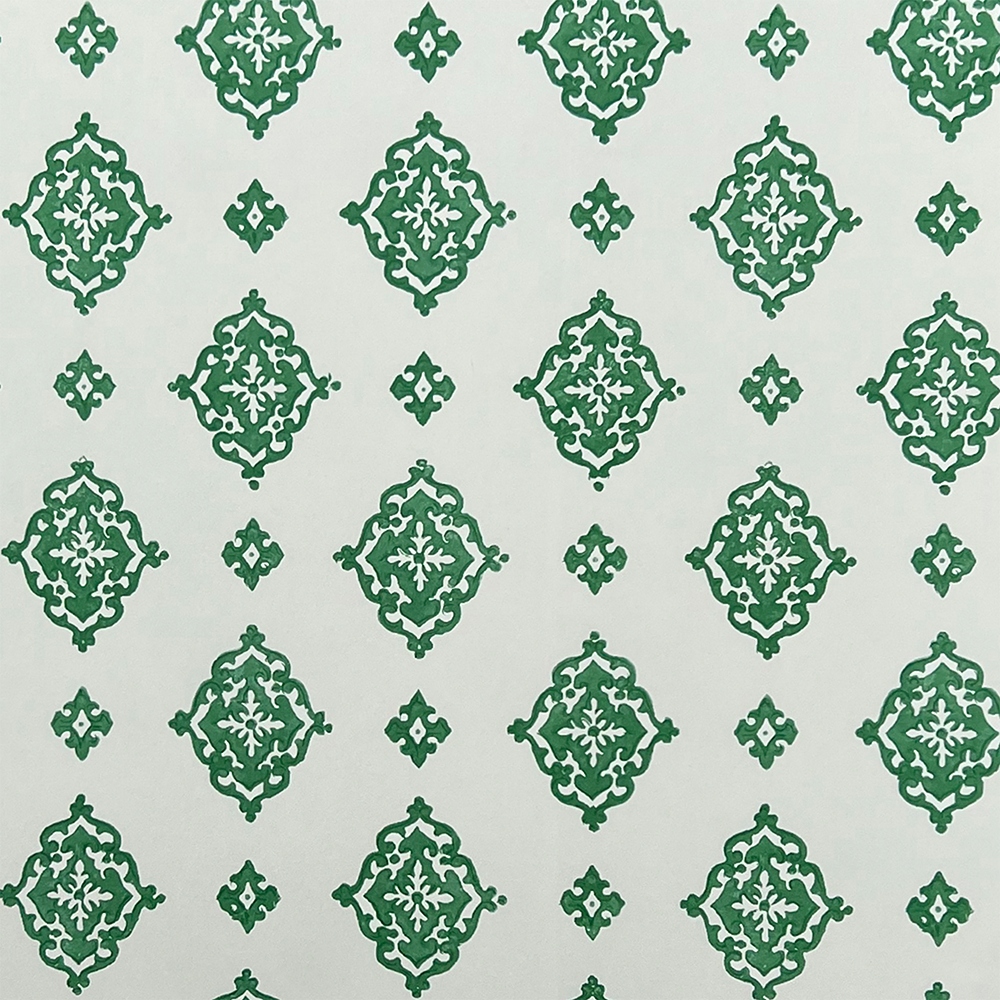 Detail of fabric in a floral damask print in green on a cream field.