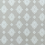 Detail of fabric in a floral damask print in cream on a light gray field.