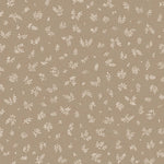 Detail of wallpaper in a minimal repeating leaf print in cream on a light brown field.