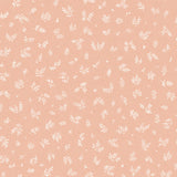 Detail of fabric in a minimal repeating leaf print in cream on a light pink field.