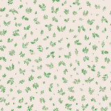 Detail of fabric in a minimal repeating leaf print in green on a white field.