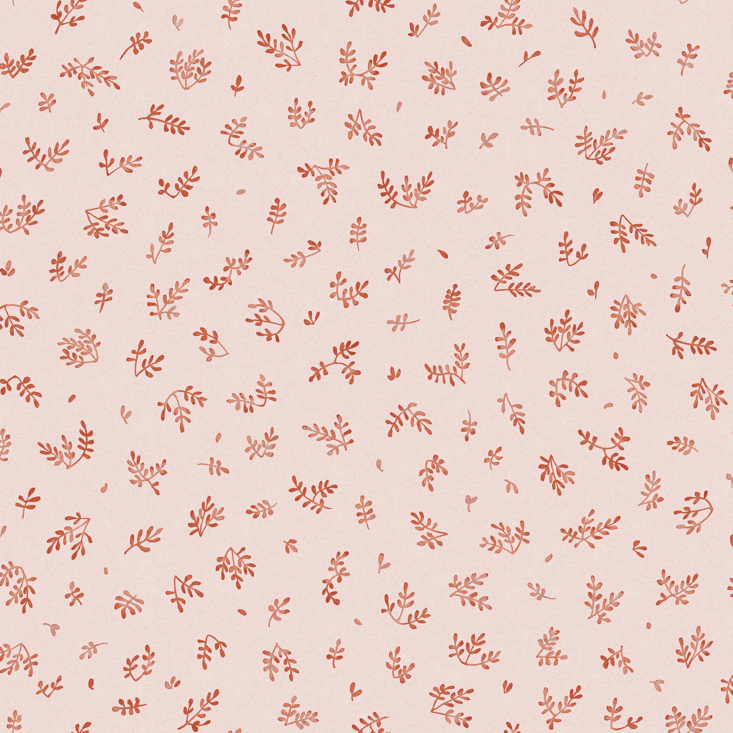 Detail of fabric in a minimal repeating leaf print in red on a light pink field.