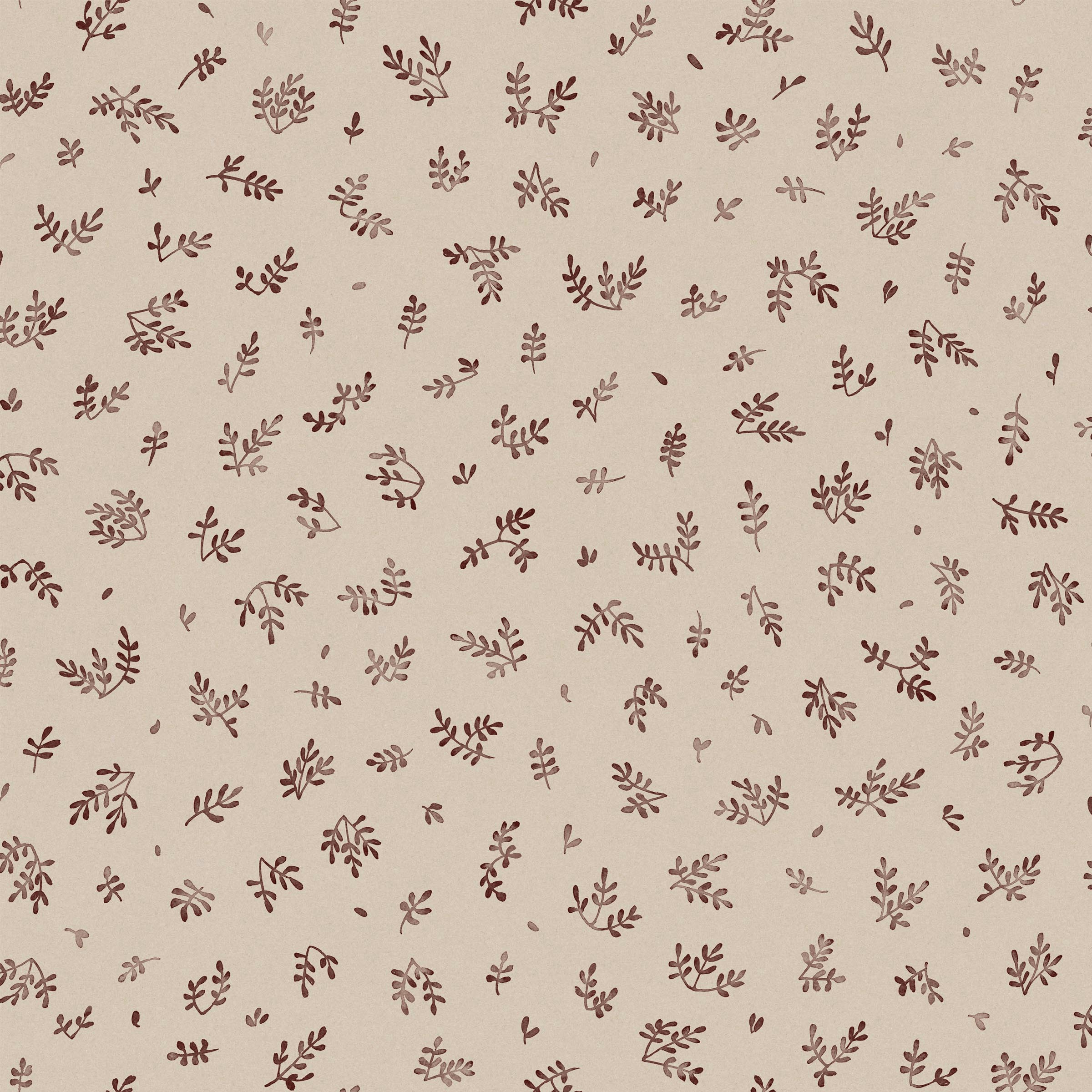 Detail of fabric in a minimal repeating leaf print in brown on a tan field.