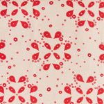 Detail of fabric in a playful paisley print in red on a tan field.