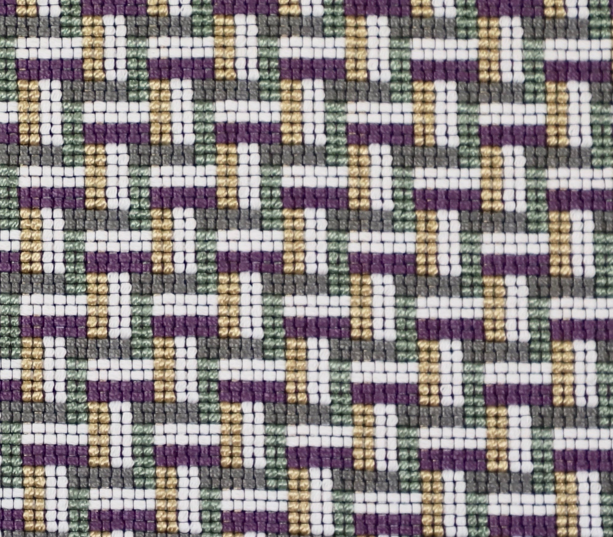 Detail of a woven stair step pattern in grey, white, tan, purple and sage green. 