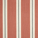 Detail of fabric in a repeating stripe print in white and gray on a burnt orange field.