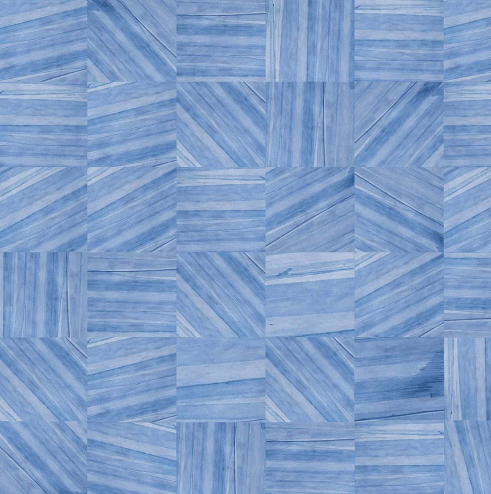 Detail of leather wall tiles in a repeating geometric pattern in shades of blue.