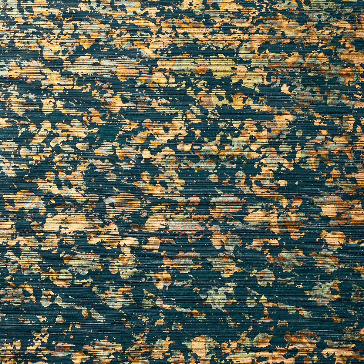 Detail of wallpaper in a paint splatter print in metallic gold and green on a navy field.