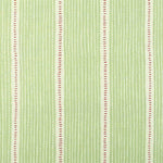 Detail of fabric in a repeating stripe and dash pattern in green and pink on a cream field.