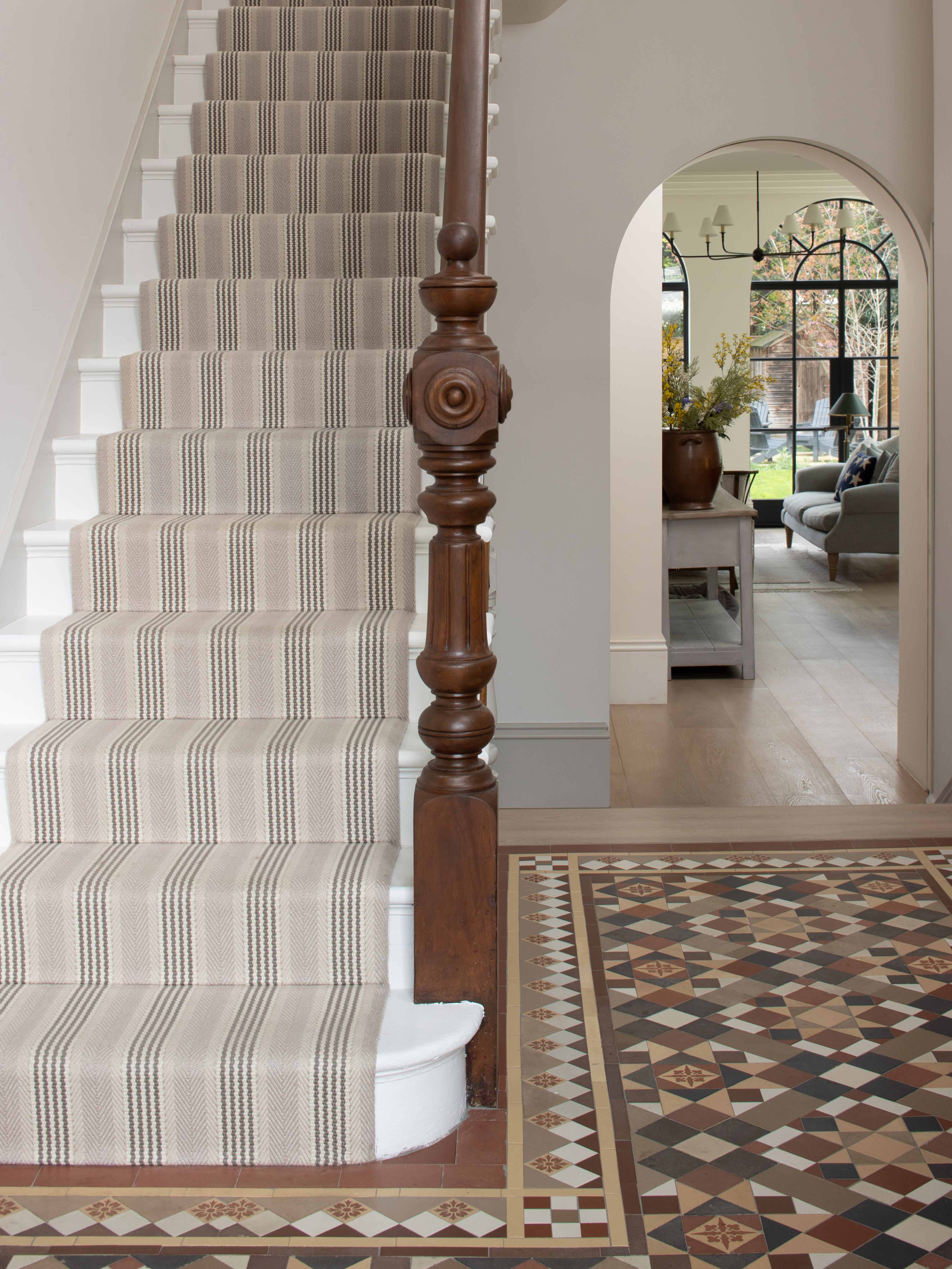 Striped flatweave runner in grey and black on white staircase