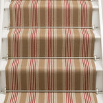 Striped flatweave runner in tan and red on white staircase