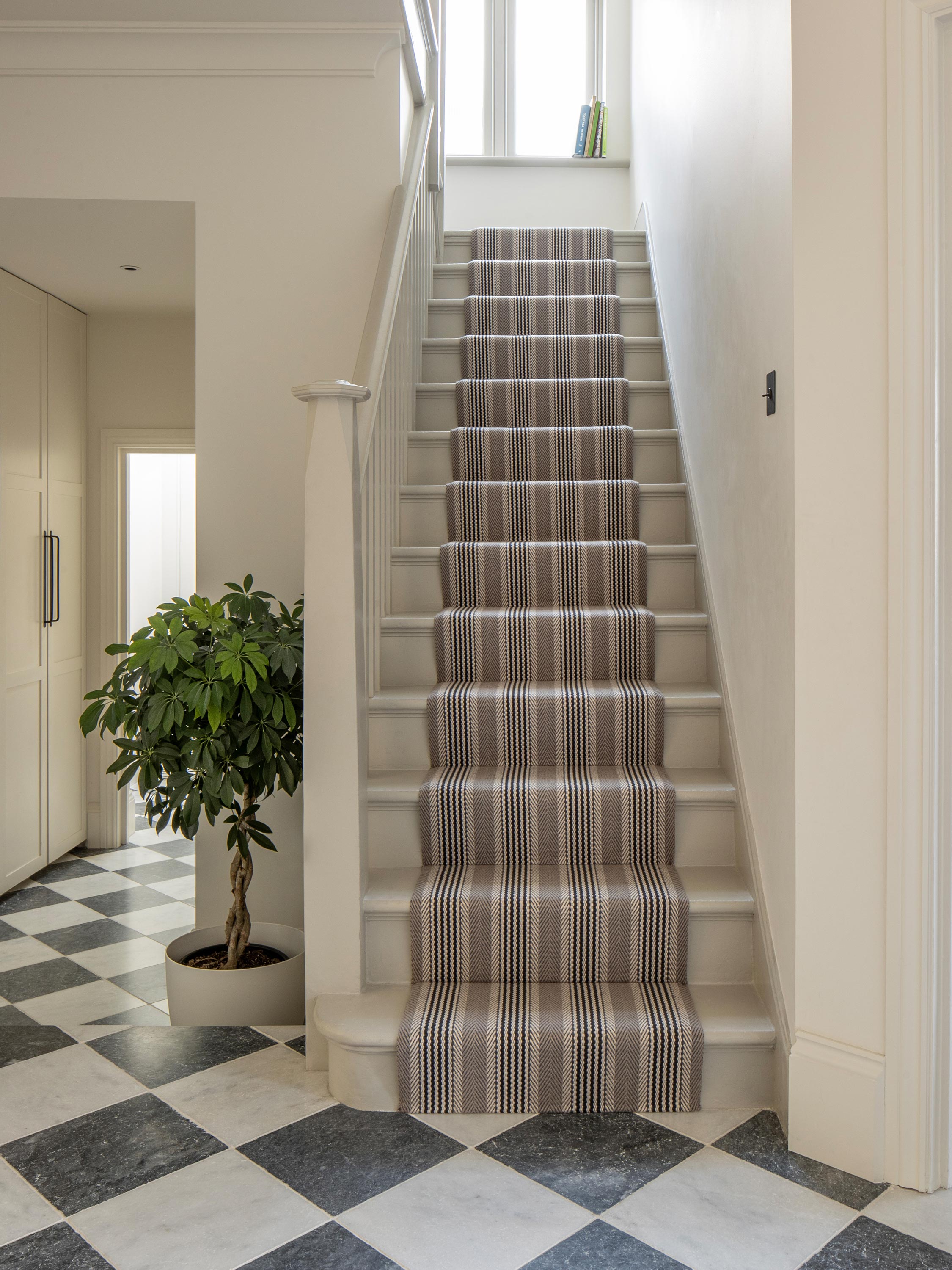 Striped flatweave runner in grey and black on white staircase