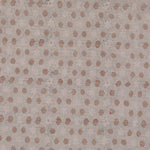 Detail of fabric in a star-shaped lattice print in tan and gray on a cream field.