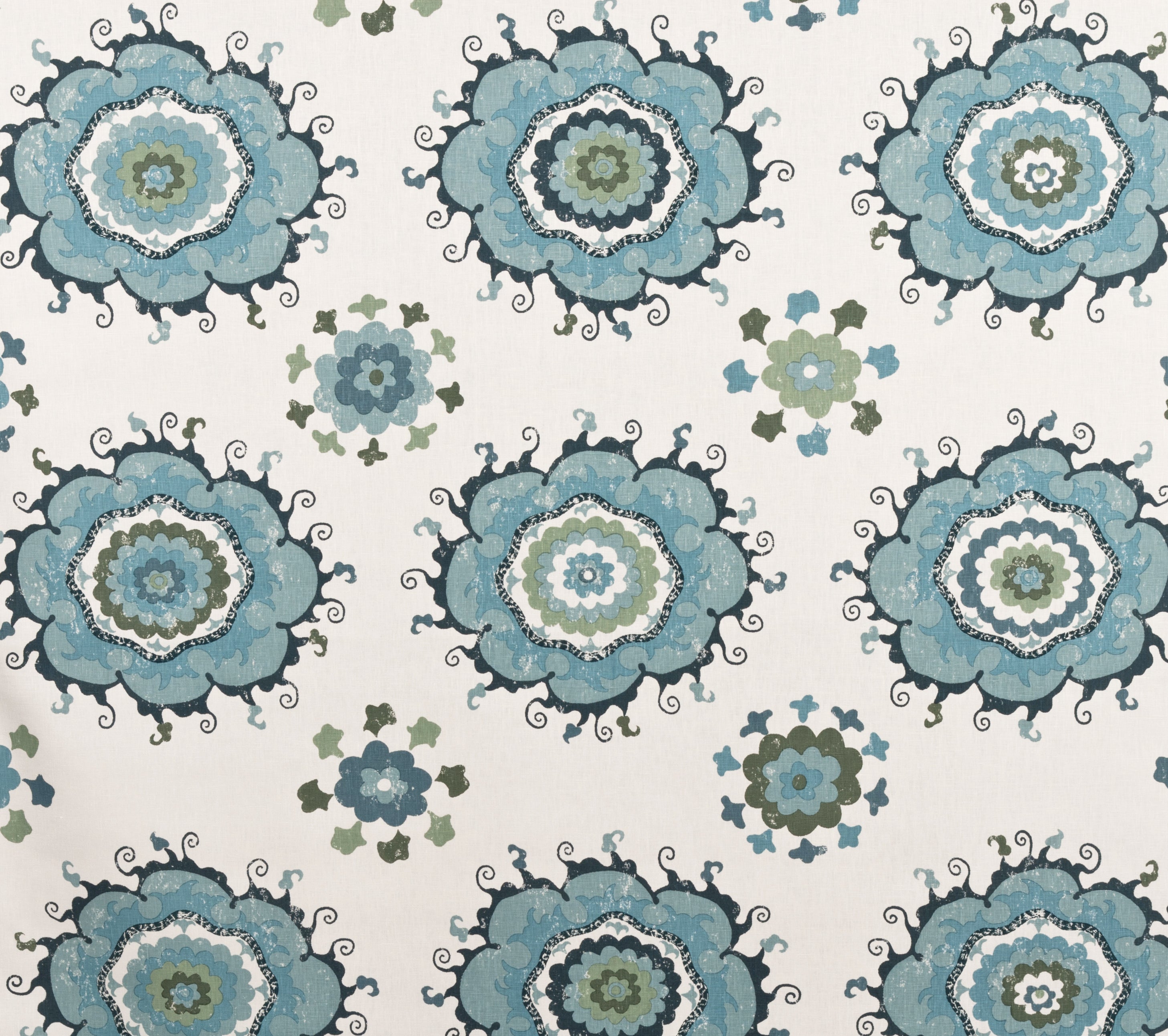 Detail of fabric in a floral paisley print in shades of blue and green on a white field.