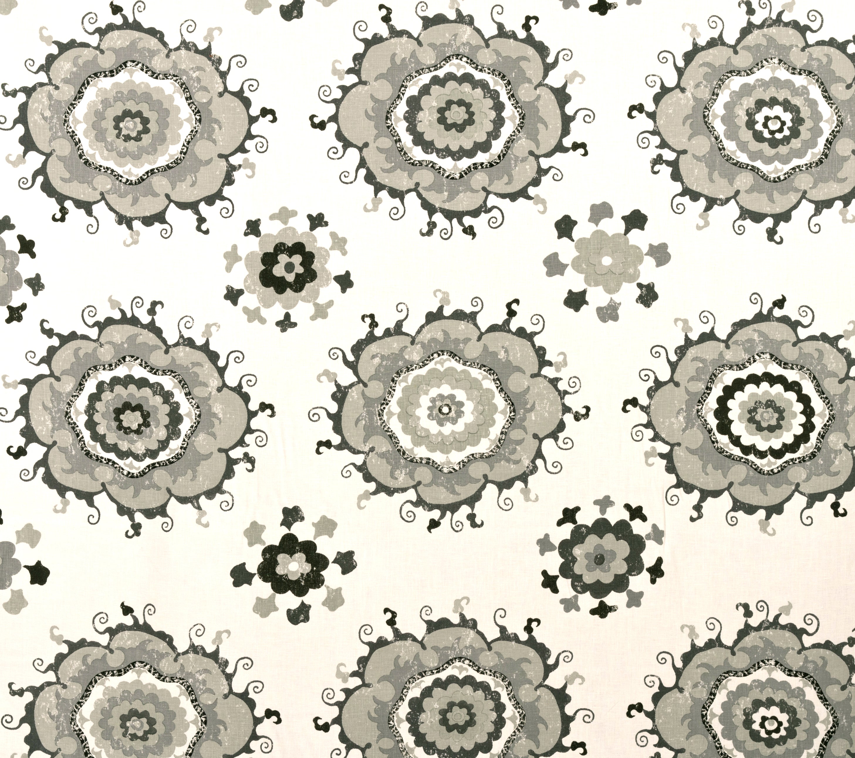 Detail of fabric in a floral paisley print in shades of brown, gray and tan on a white field.