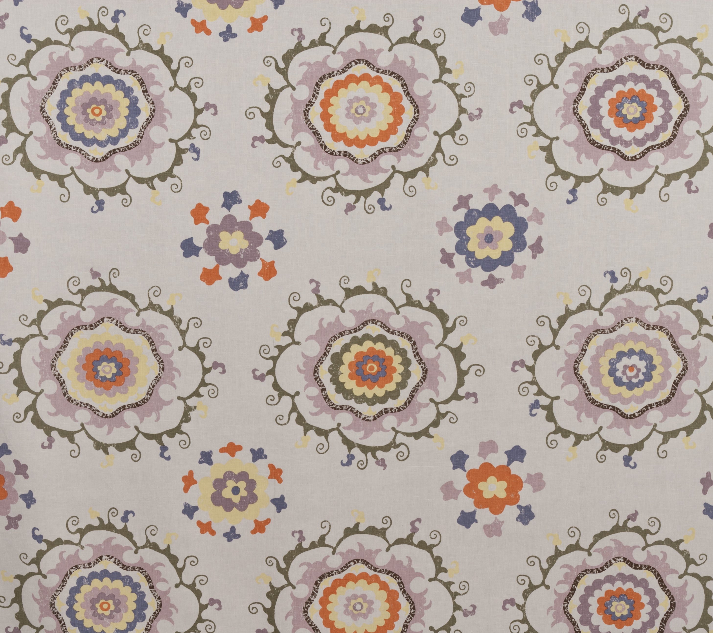 Detail of fabric in a floral paisley print in shades of purple, orange and yellow on a gray field.