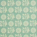 Detail of fabric in a repeating sunflower print in cream on a light turquoise field.