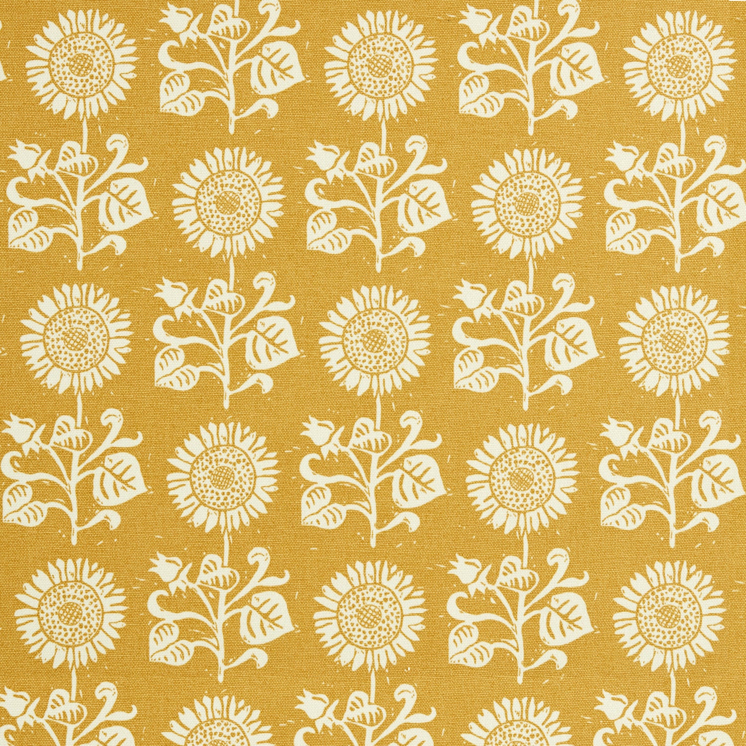 Detail of fabric in a repeating sunflower print in white on a mustard field.