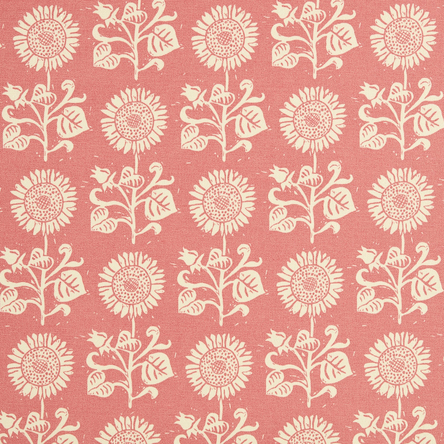 Detail of fabric in a repeating sunflower print in cream on a pink field.