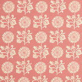 Detail of fabric in a repeating sunflower print in cream on a pink field.