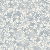 Detail of fabric in a painterly branch print in white on a blue-gray watercolor field.