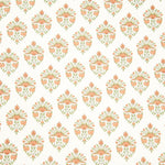 Detail of fabric in a floral paisley print in shades of green and coral on a white field.