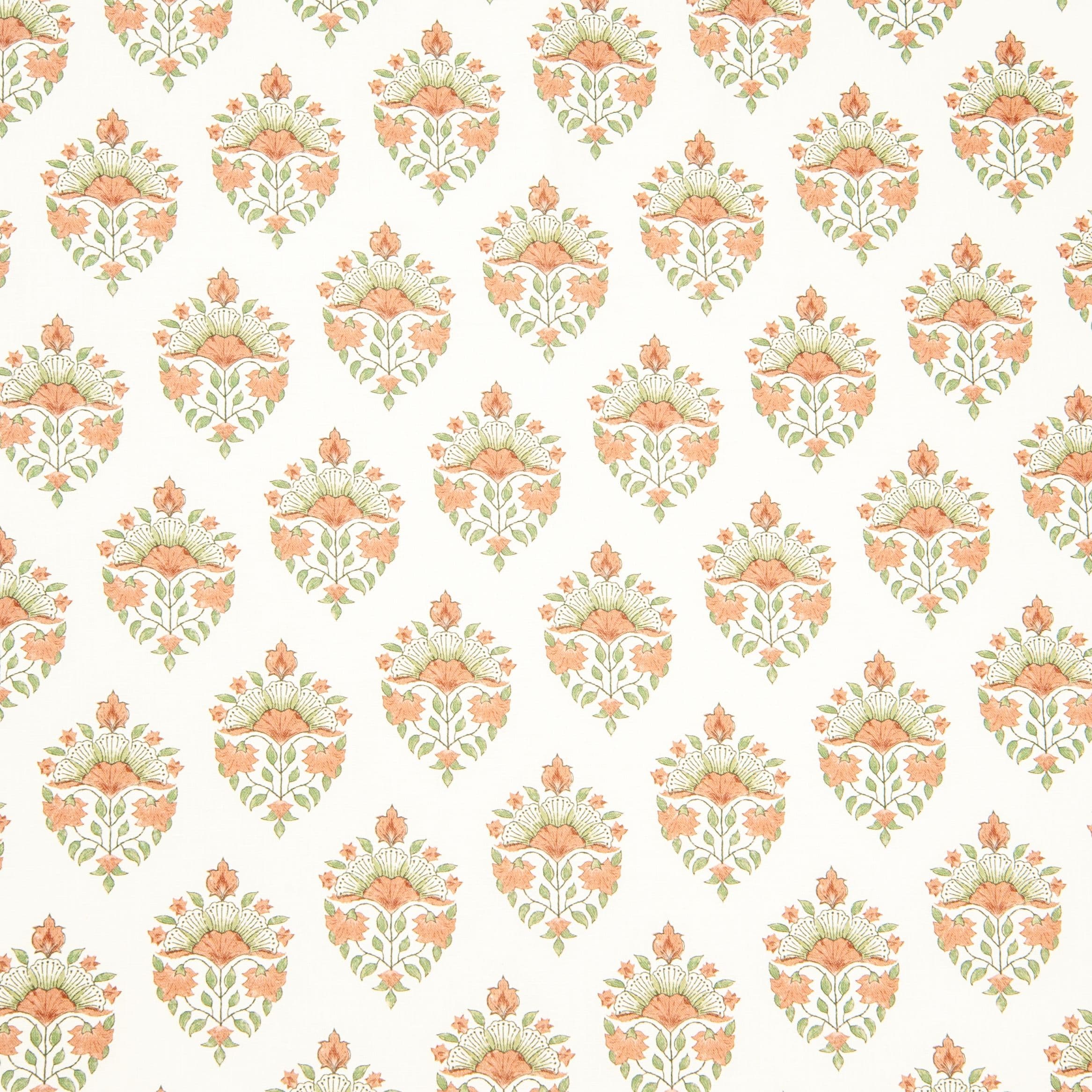 Detail of fabric in a floral paisley print in shades of green and coral on a white field.