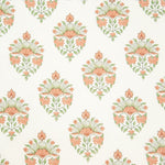 Detail of wallpaper in a floral paisley print in shades of green and coral on a white field.