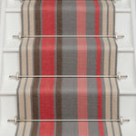 Striped flatweave runner in pink red grey and cream on white staircase