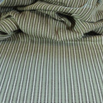 Draped textile fabric with a green and cream striped pattern