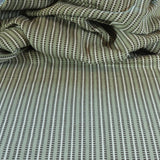 Draped textile fabric with a green and cream striped pattern
