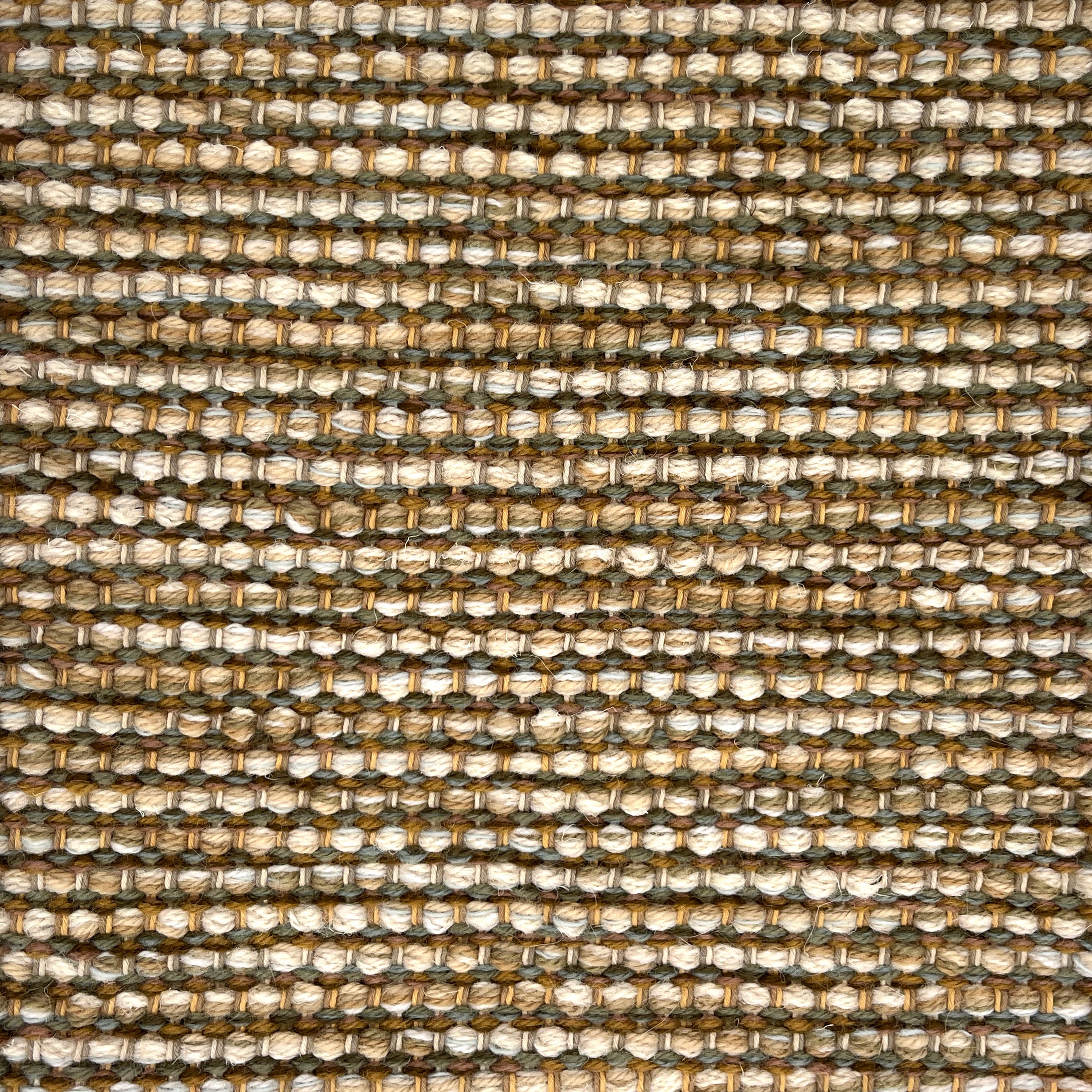 Textured handwoven rug with a strié pattern in earth tones.